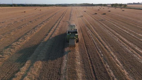 Square Hay Bales making with Hay Baler tractor aerial view from a drone Stock Footage 280386495