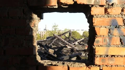 A Square hole In A Brick Wall Showing Incinerated Roof Ruins Stock Footage 130900964