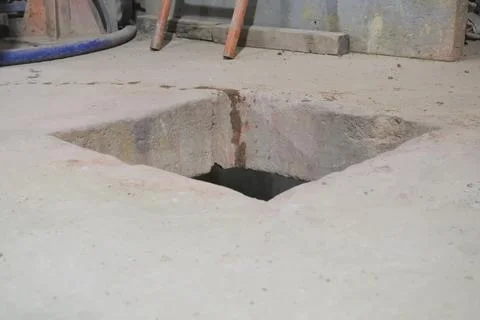 Square hole in concrete floor for technological needs Stock Photos