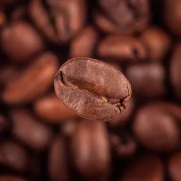 Square image coffee background close-up. Focus on one grain Stock Photos