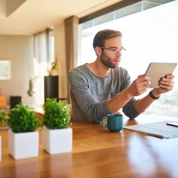 Square image of white man busy reading a digital tablet Stock Photos
