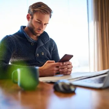 Square image of young man texting on his mobile phone Stock Photos