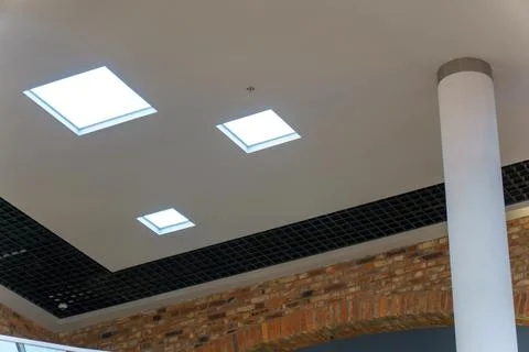 Square lamp on a white office ceiling. Interior design in the office. A fluor Stock Photos