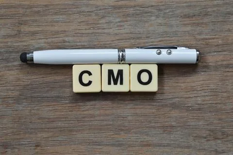 Square letters with text CMO stands for CHIEF MARKETING OFFICER. Stock Photos