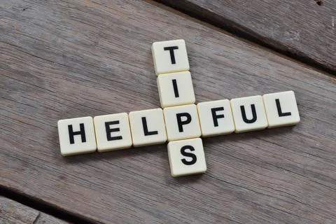 Square letters with text HELPFUL TIPS. Top view. Stock Photos