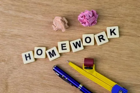 Square letters with text HOMEWORK over wooden background. Stock-Fotos
