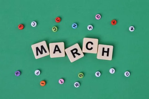 Square letters with text MARCH over green background. Stock Photos