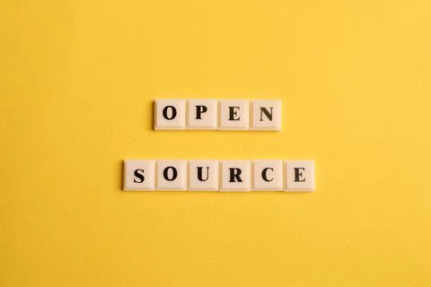 Square letters with text OPEN SOURCE isolated on yellow background Stock Photos