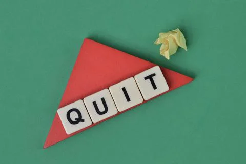 Square letters with text QUIT over green background. Stock Photos