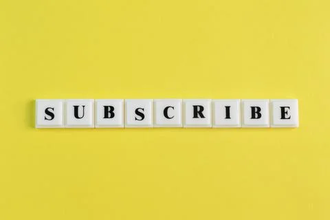 Square letters with text SUBSCRIBE isolated on a yellow background Stock Photos