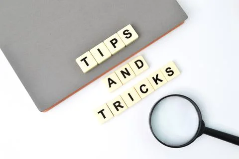 Square letters with text TIPS AND TRICKS OVER WHITE BACKGROUND. Stock Photos