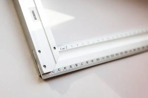 A square on light background with centimeter scale, triangular tool Stock Photos