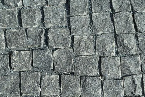 Square lined with cobblestone or stone pavement, walkway or road. Stock Photos
