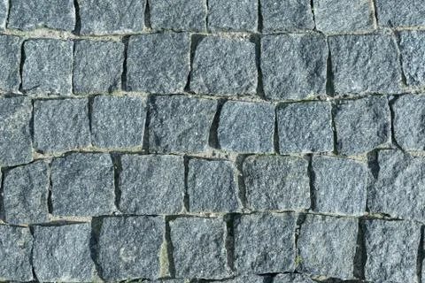 Square lined with cobblestone or stone pavement, walkway or road. Stock Photos