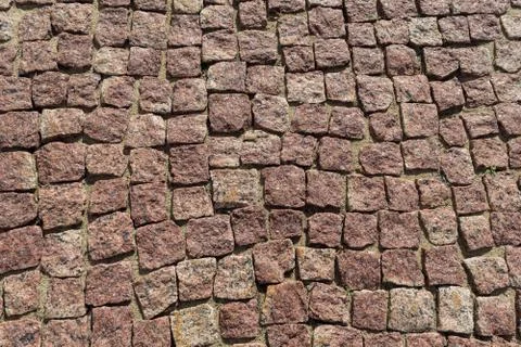 Square lined with cobblestone or stone pavement, walkway or road. Stock Photos