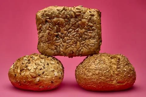Square multigrain bread on two buns over pink background Stock Photos