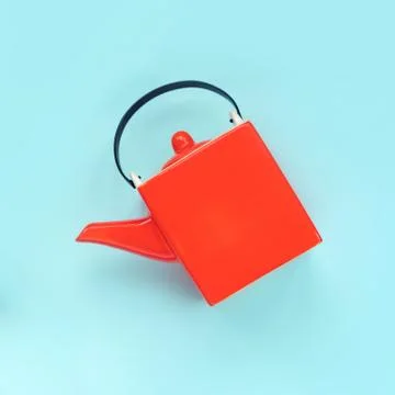 Square orange teapot. Creative concept. Tea time. Photos