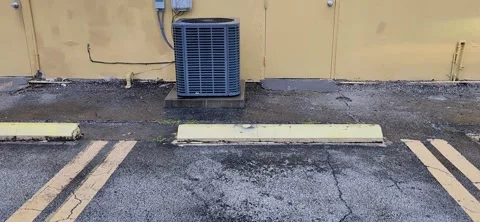 Square outdoor air conditioning unit in backyard of office and shopping cente Stock Footage 327067274