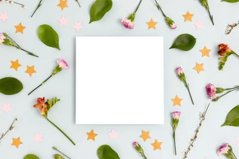 Square paper card mockup. Pattern made of flowers and confetti. Stock Photos