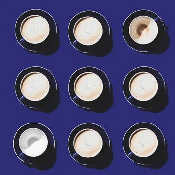 A square pattern of blue cups on a blue background. Coffee break. Stock Photos