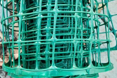 Square pattern green plastic flexible garden fence rolled up Fotos Stock
