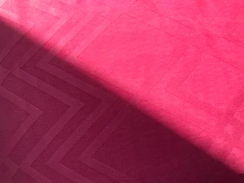 Square pattern pink fabric and sun light shine half on it as diagonal Stock Photos