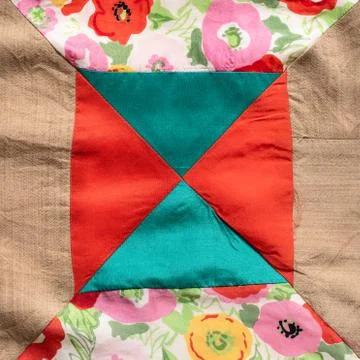 Square piece of hand-stitched patchwork cloth Stock Photos