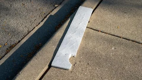 Square Piece of Styrofoam with Chunk Missing on Sidewalk Stock Photos