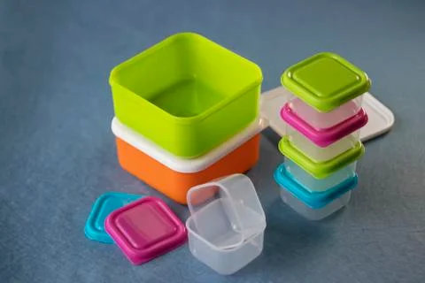 Square plastic containers with bright multi-colored lids. Stock Illustration