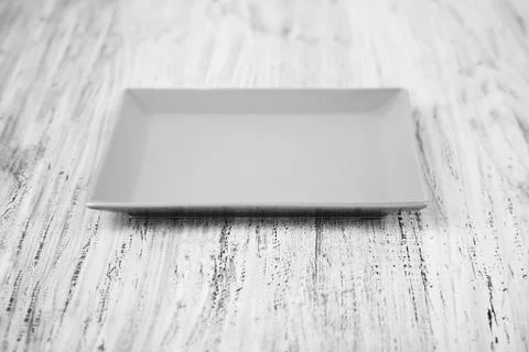 Square plate on a wooden background Stock Photos