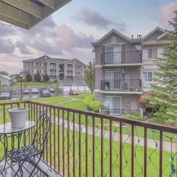 Square Puffy clouds at sunset View of an apartment buildings with lawn at the Stock Photos