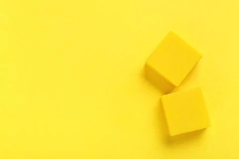 Square rubber erasers on yellow background Stock Photos