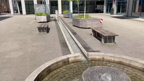 In a square in Schopfheim, Germany, water flows from a spring into a small 스톡 동영상 338050429