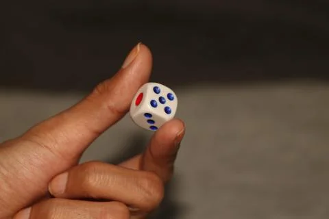 Square shape dice hold in hand Stock Photos