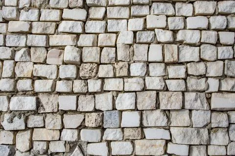 Square shaped granite stone cubes arranged randomly as a wall decoration, a.. Stock Photos