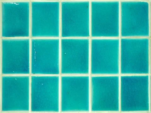 Square shaped green glazed tile wall. Stock Photos