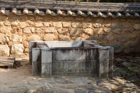 Square shaped stone well Stock Photos