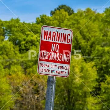 Square Sign that reads Warning No Trespassing Ogden City Police Letter Of Agency Stock Photos