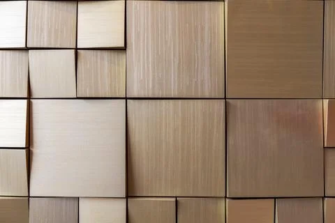 Square silver tiles of different sizes on the wall. rough surface texture Stock Photos