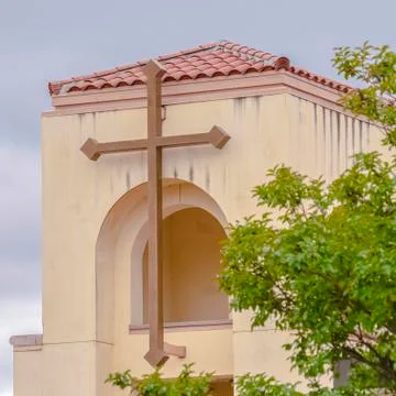 Square Simple cross on the bell tower of a small church Stock Photos
