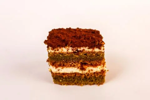 Square slice of layered sponge cake with two thick ribbons of whipped cream Stock Photos