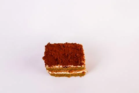 Square slice of layered sponge cake with two thick ribbons of whipped cream Stock Photos