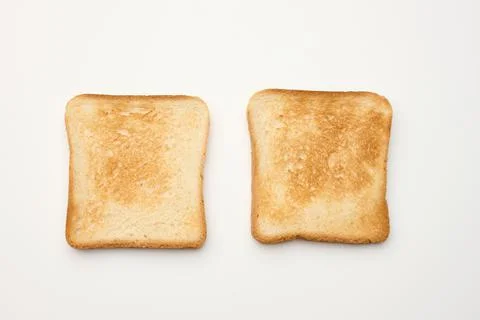 Square slices of bread made from white wheat flour toasted in toaster, top vi Stock Photos