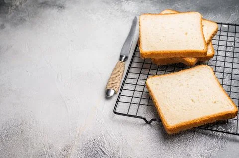 Square Slices of  loaf wheat bread for toasts. white background. top view Foto stock