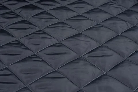 Square stitched on a black patchwork quilt Stock Photos