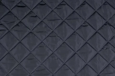 Square stitched on a black patchwork quilt Stock Photos