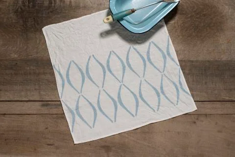 Square Table Napkin with Blue Concave Lines Alongside Blue Tray Stock Photos