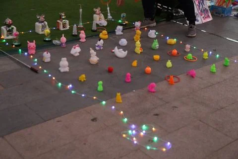 In the square, there is an array of colorful LED lights on concrete slabs a.. Stock Photos