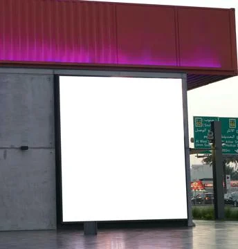 Square white empty signage on a building lit up with lights. Blank white Bill Stock Photos