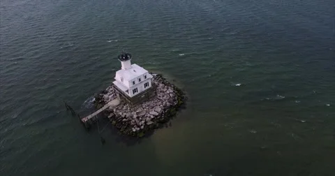 Square white lighthouse on a rock crib in open bay water Video stock 62145536
